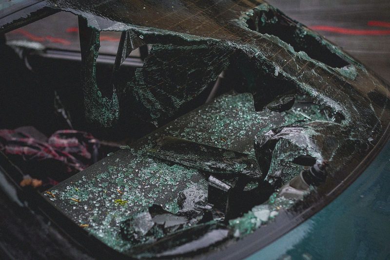 Cracked car windshield showing damage that comprehensive car insurance covers