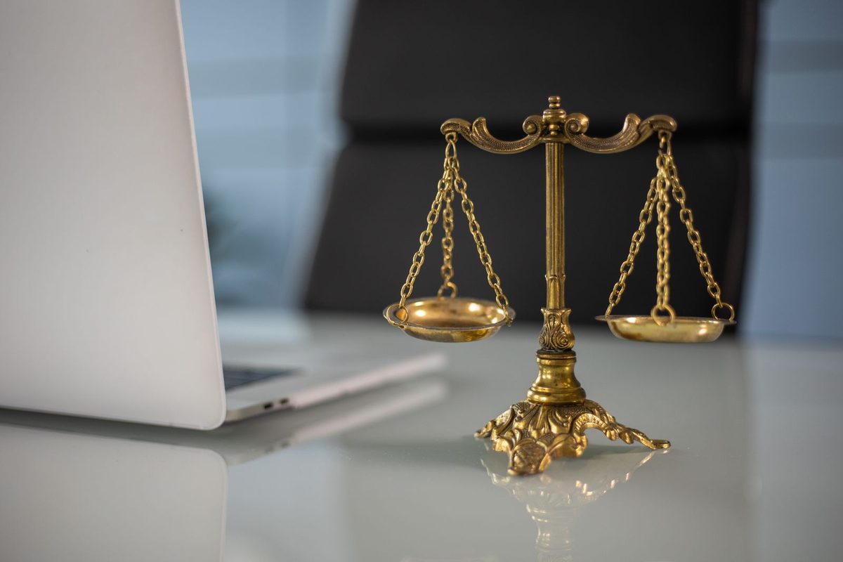 Scales of justice and law books representing criminal defense attorney costs