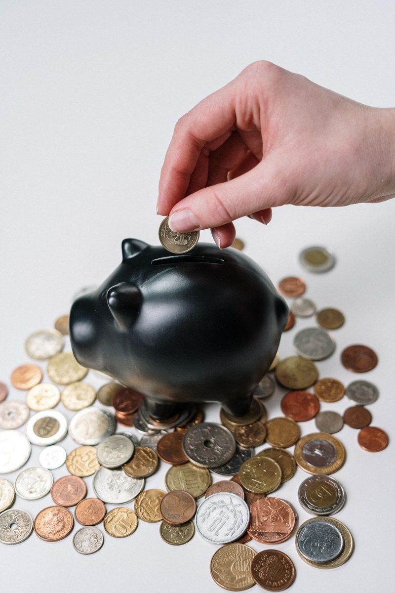 Adding a coin to a savings jar, representing compounding retirement contributions